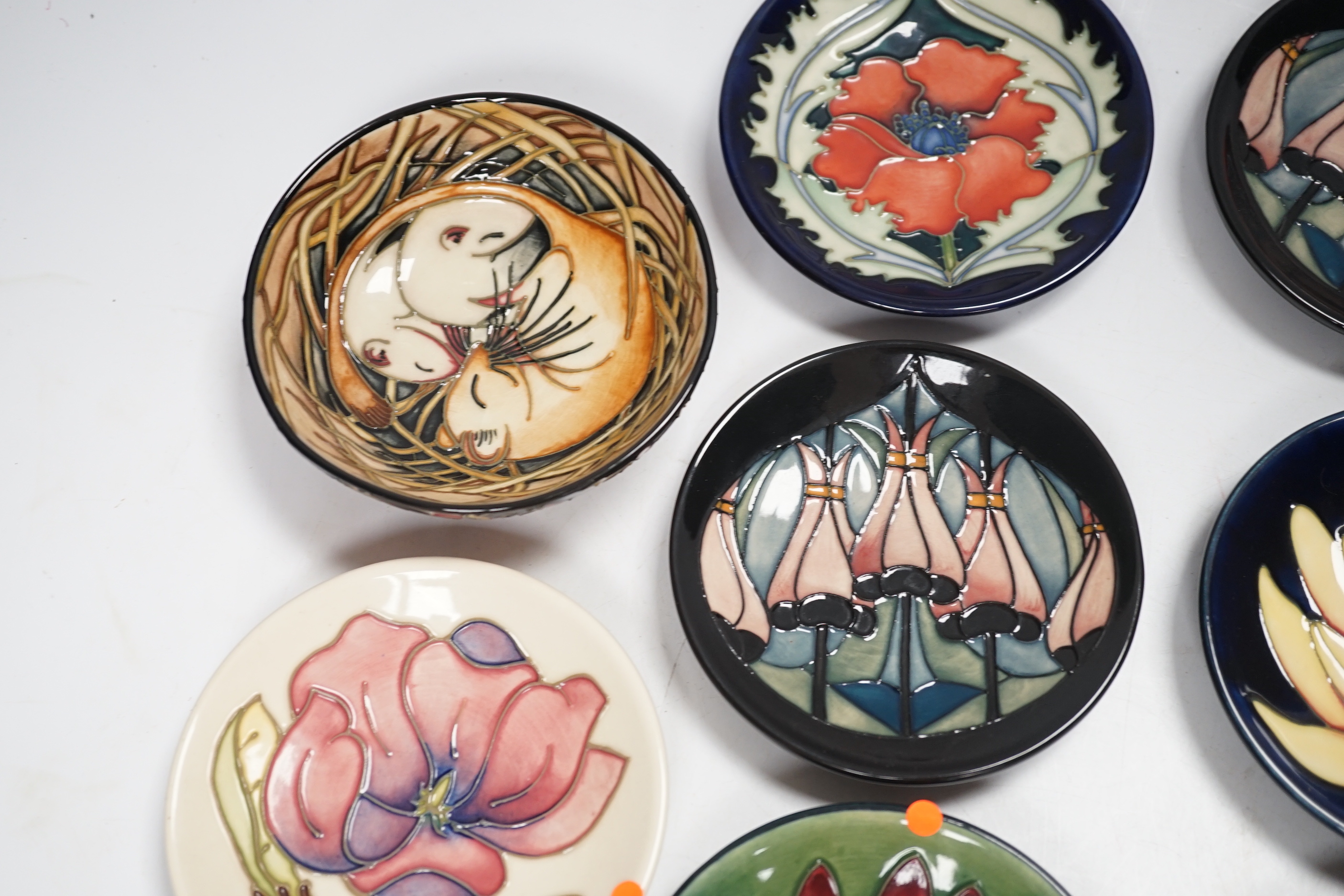 Seven Moorcroft floral dishes, two with Kerry Goodwin stamp to the base and a dormouse bowl designed by Emma Bossons, limited edition 14/100, 12cm in diameter